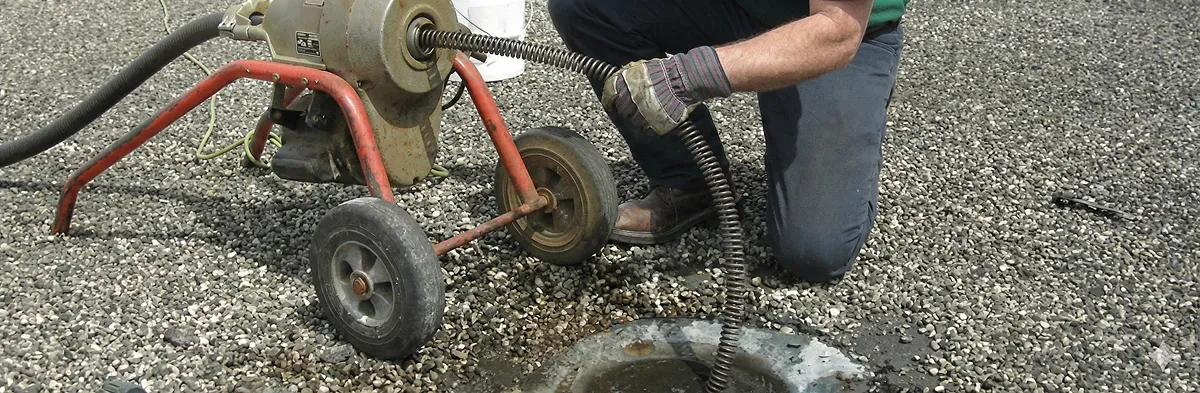 sewer rodding technician actively removing blockages from a sewer line in Pittsburgh, PA